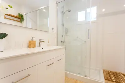 a white bathroom with a shower and a sink at Casa Ros-PLAYA free parking by Cadiz4Rentals in Cádiz
