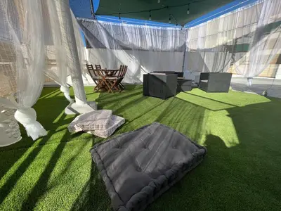a tent with a mattress on the grass at Casa Ana in Sanlúcar de Barrameda