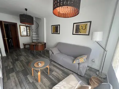 a living room with a couch and a table at Casa Ana in Sanlúcar de Barrameda