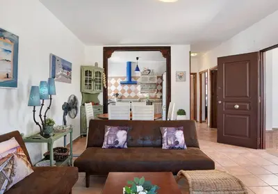 a living room with a couch and a table at Villa Ébano in Conil de la Frontera