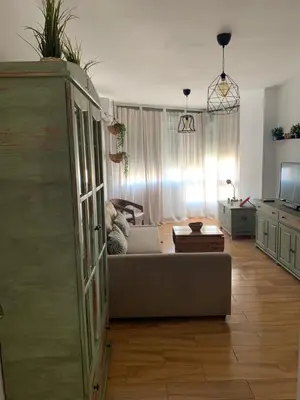 a living room with a couch and a table at Sanlúcar Playa in Sanlúcar de Barrameda