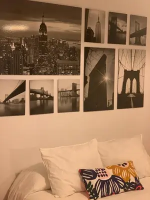 a bunch of pictures on a wall above a couch at Sanlúcar Playa in Sanlúcar de Barrameda