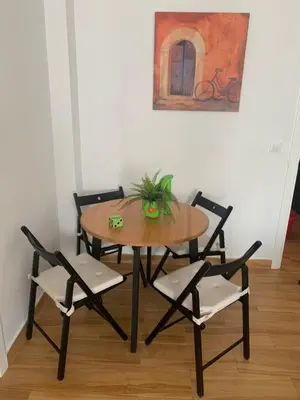 a dining room table and chairs with a plant on it at Sanlúcar Playa in Sanlúcar de Barrameda