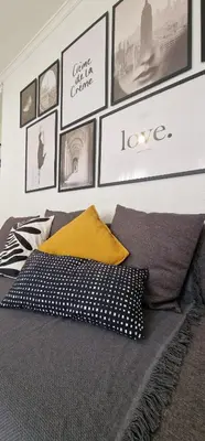 a bedroom with a bed with pillows and pictures on the wall at apartamento céntrico jerez calle tucan n17 in Jerez de la Frontera