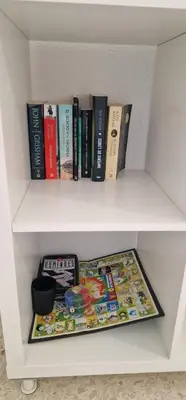 a white book shelf with books on it at apartamento céntrico jerez calle tucan n17 in Jerez de la Frontera