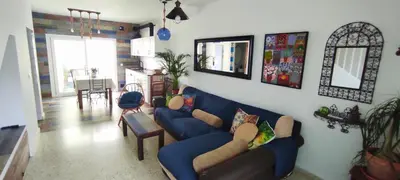 a living room with a blue couch and a table at La Barrosa duplex in Chiclana de la Frontera