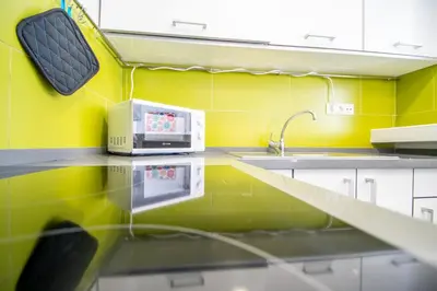 a kitchen with a sink and a microwave on a counter at Apartamento El Rayo Verde in Cádiz