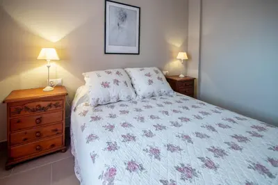 a bedroom with a bed and two night stands at Apartamento Paseo Maritimo 27 in Cádiz