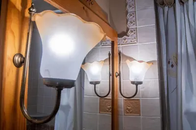 a pair of lights in a bathroom with a mirror at Apartamento Paseo Maritimo 27 in Cádiz