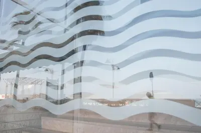 a reflection of a building in a window at Apartamento Paseo Maritimo 27 in Cádiz