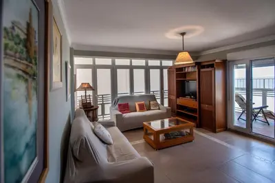 a living room with a couch and a tv at Apartamento Paseo Maritimo 27 in Cádiz