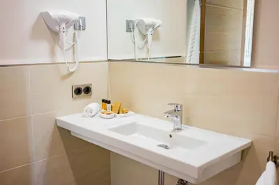 a bathroom with a sink and a mirror at Hotel Boutique Aroma de Mar in Chiclana de la Frontera