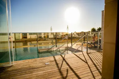 a view of a swimming pool from a balcony at Hotel Boutique Aroma de Mar in Chiclana de la Frontera