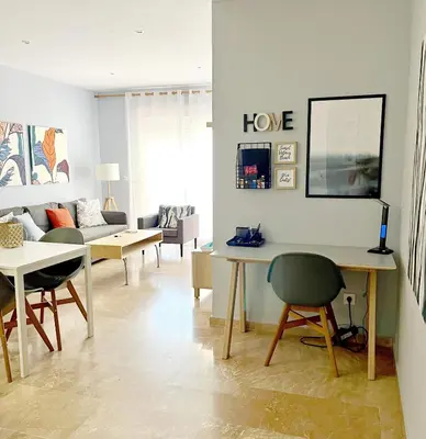 a living room with a table and a couch at Sunset Victoria Beach in Cádiz