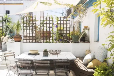 a patio with a table and chairs and plants at amazing Penthouse Cadiz in Cádiz