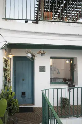 a green door on a house with a balcony at amazing Penthouse Cadiz in Cádiz
