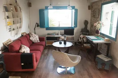 a living room with a red couch and a table at amazing Penthouse Cadiz in Cádiz