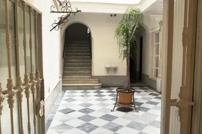 a hallway with a staircase and a potted plant at amazing Penthouse Cadiz in Cádiz