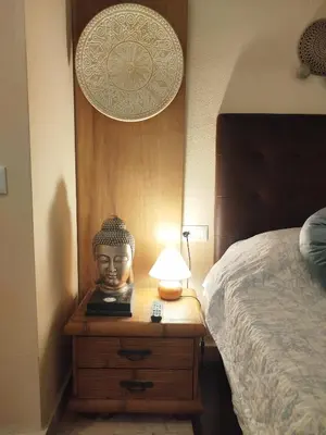 a bedroom with a bed and a lamp on a night stand at Indo en OGGOB com in Chiclana de la Frontera