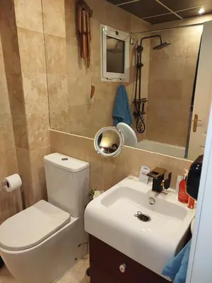 a small bathroom with a toilet and a sink at Indo en OGGOB com in Chiclana de la Frontera