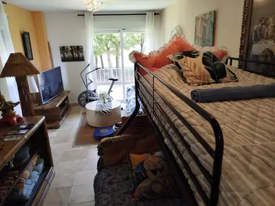a bedroom with a bed and a tv in a room at Indo en OGGOB com in Chiclana de la Frontera