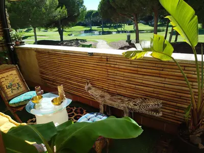 a patio with a jaguar statue and a table with drinks at Indo en OGGOB com in Chiclana de la Frontera