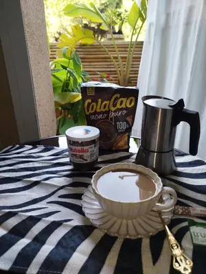 a table with a cup of coffee and a bowl of milk at Indo en OGGOB com in Chiclana de la Frontera