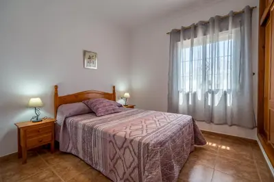 a bedroom with a bed and a window at Chalet Miriam I in Conil de la Frontera