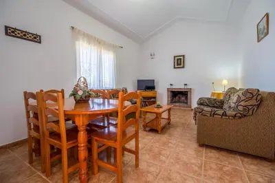a living room with a table and chairs and a couch at Chalet Miriam I in Conil de la Frontera
