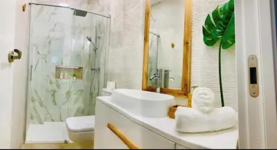 a bathroom with a sink and a shower and a toilet at Gosol Lemon, Centro-Parking in Sanlúcar de Barrameda