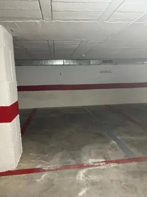 an empty parking garage with a red and white wall at Gosol Lemon, Centro-Parking in Sanlúcar de Barrameda