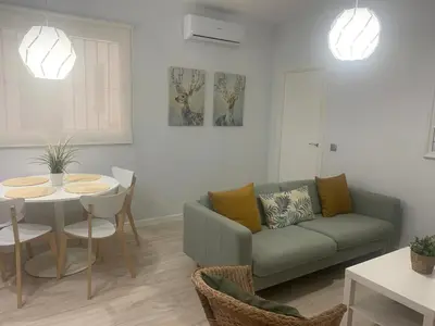 a living room with a couch and a table at Gosol Lemon, Centro-Parking in Sanlúcar de Barrameda