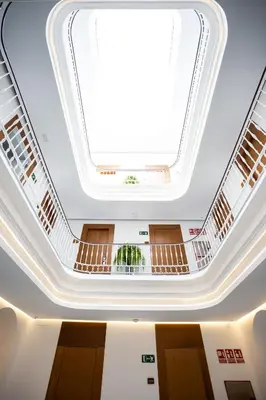 a large skylight in the ceiling of a building at Plazuela del Carbón Suites in Cádiz