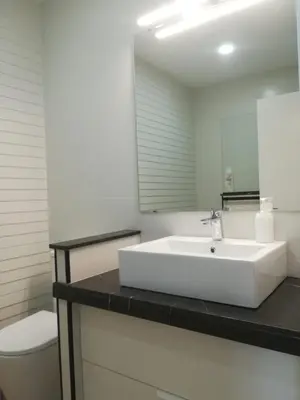 a bathroom with a white sink and a toilet at Luz de Cádiz in Cádiz