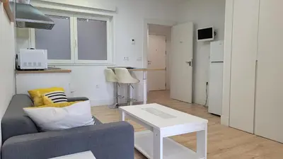 a living room with a couch and a table at Luz de Cádiz in Cádiz