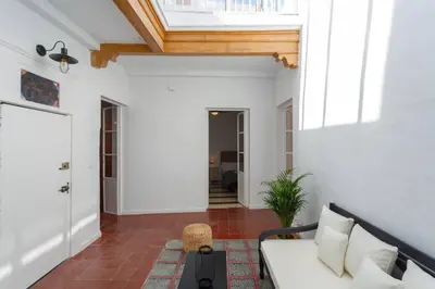 a living room with a white couch and a skylight at SH La Casa del Loro. Amplio apartamento. in Cádiz