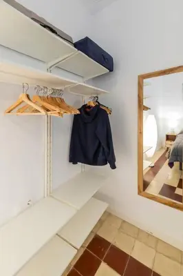 a dressing room with a mirror and a blue shirt at SH La Casa del Loro. Amplio apartamento. in Cádiz