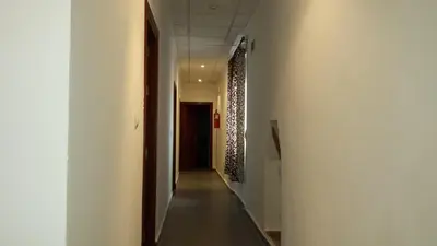 a hallway with a long corridor with white walls at Hostal Cuesta de Belén in Arcos de la Frontera