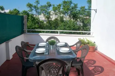 a blue table and chairs on a balcony with a view at El mirador del Mentidero in Cádiz