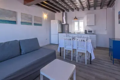 a living room with a couch and a table and chairs at El mirador del Mentidero in Cádiz