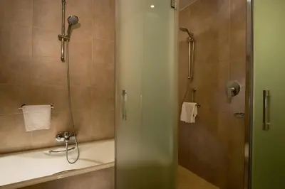 a bathroom with a shower and a sink at Suites Puerto Sherry in El Puerto de Santa María