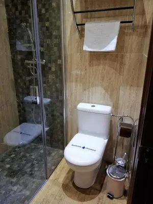 a bathroom with a toilet and a glass shower at Hotel LB Lebrija by MA 22 Puntos in Lebrija