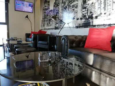 a living room with a couch and a glass table at Hotel LB Lebrija by MA 22 Puntos in Lebrija