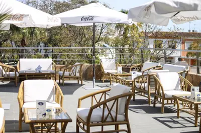 a group of chairs and umbrellas on a patio at Hotel LB Lebrija by MA 22 Puntos in Lebrija