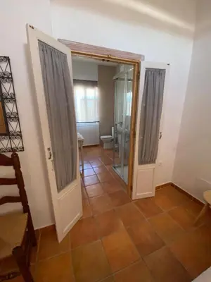 a bathroom with a shower and a glass door at Hotel Rural Casa Fina - Adults Recommended in Conil de la Frontera