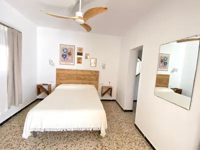 a white bedroom with a bed and a mirror at Hotel Rural Casa Fina - Adults Recommended in Conil de la Frontera
