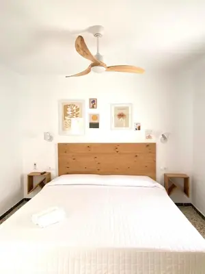 a bedroom with a bed with a ceiling fan at Hotel Rural Casa Fina - Adults Recommended in Conil de la Frontera