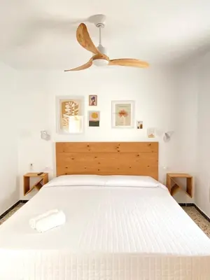 a bedroom with a bed with a ceiling fan at Hotel Rural Casa Fina - Adults Recommended in Conil de la Frontera