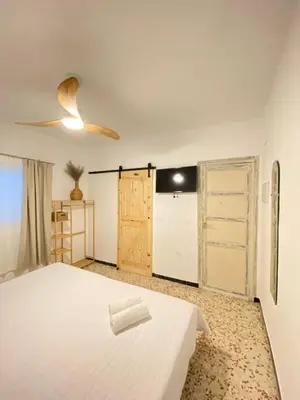 a bedroom with a white bed and a closet at Hotel Rural Casa Fina - Adults Recommended in Conil de la Frontera