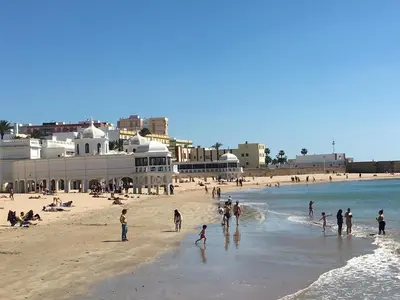 a group of people playing on the beach at Acogedor y luminoso apartamento in Cádiz